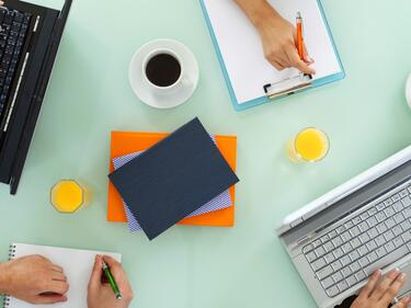 Top down picture of meeting table with laptops