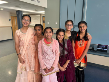 Group of female middle school students in traditional attire celebrating Diwali