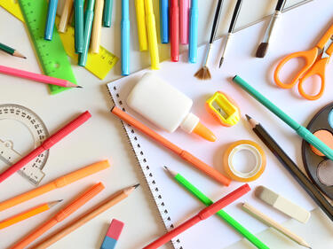 Picture of various school supplies scattered on table
