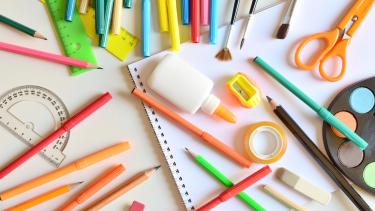 Picture of various school supplies scattered on table