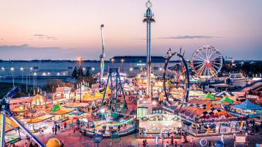 picture of lit up carnival with rides and games