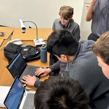 Students working collaboratively with a laptop