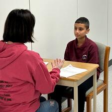 Student being interviewed by teacher