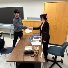 Teacher and student shaking hands