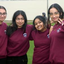 A group of four students smiling