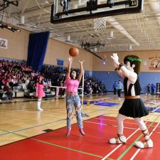 Pep Rally with student playing basketball against Titan mascot